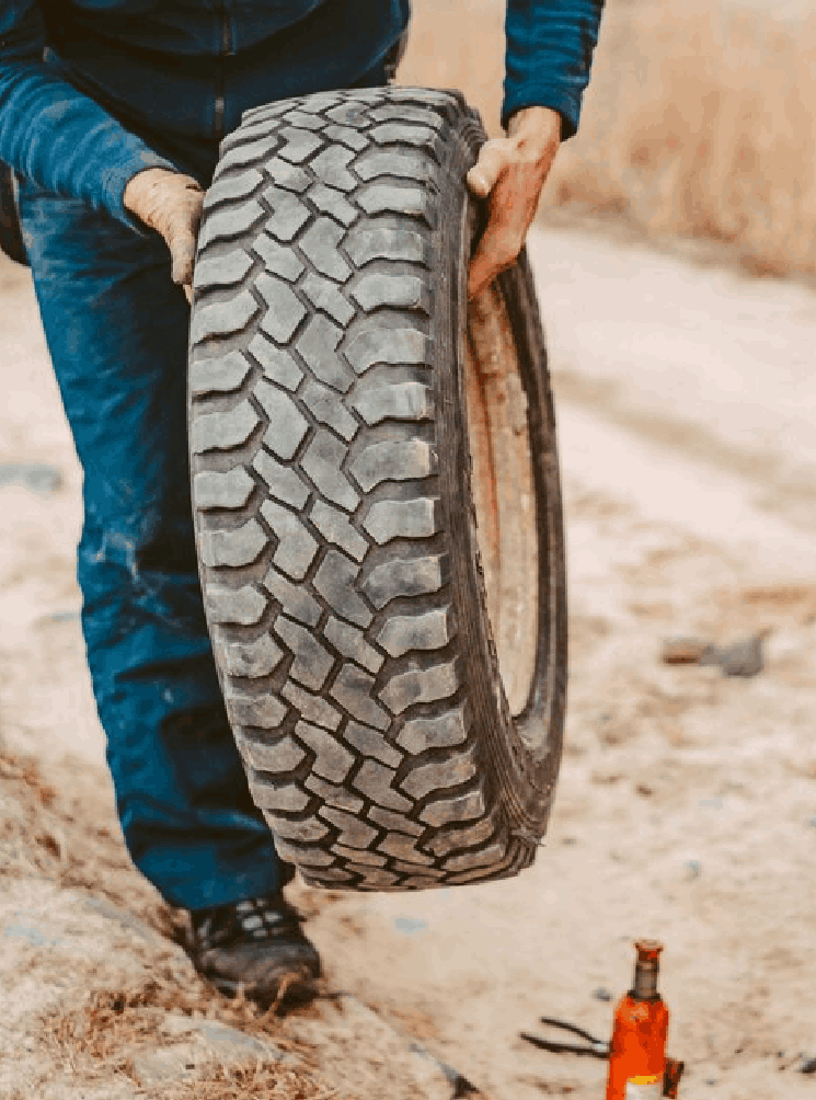 Man change the wheel manually on a 4x4 off road truck<br />
